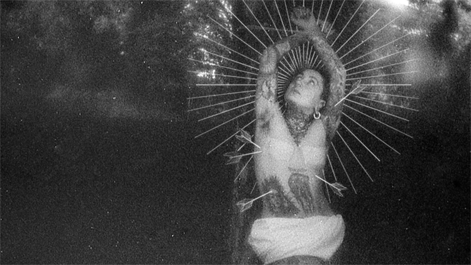 A person is posing like Jesus on the cross