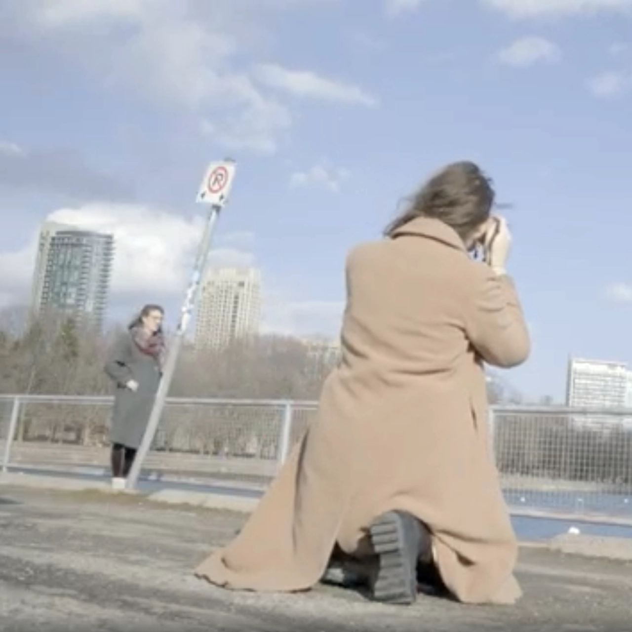 A person seen from behind, taking a photo